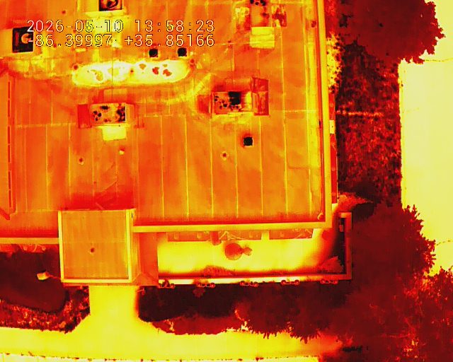 Thermal drone image of a commercial roof revealing a moisture heat signature