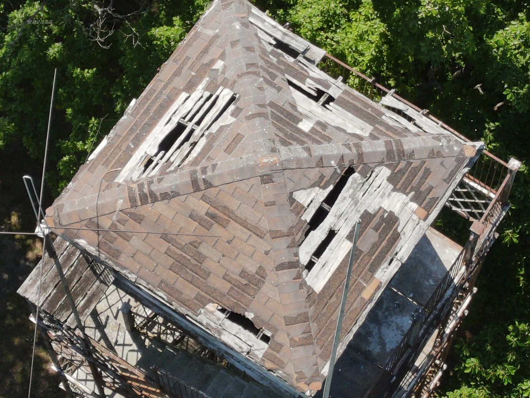 Aerial inspection photo of a lookout tower roof showing deteriorated covering